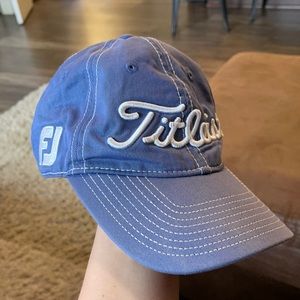 Blue titleist hat with white lettering